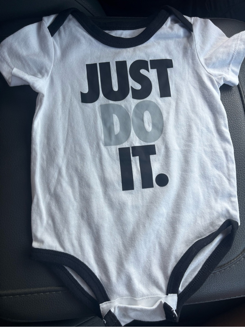 Nike White and Black "Just Do It." Kids One-Piece Bodysuit